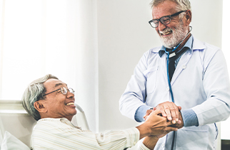 doctor holding hands with patient.