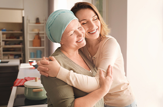 nurse hugging cancer patient