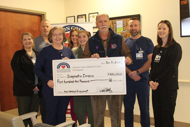 members of foundation with large check for 410,000 dollars