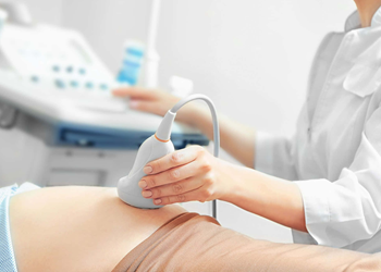 Ultrasound equipment being used on a patient.