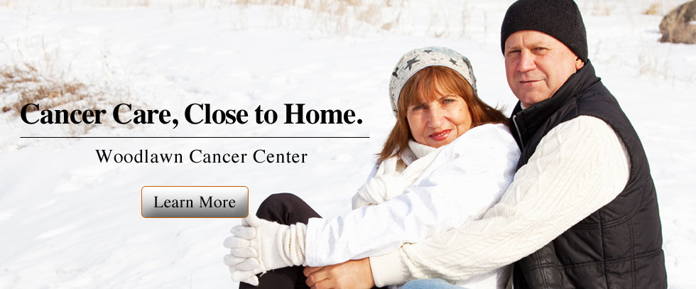 Banner picture of a man and woman sitting in snow. They are dressed warm and wearing toboggans and the woman has on gloves. Banner says:
Cancer Care, Close to home.