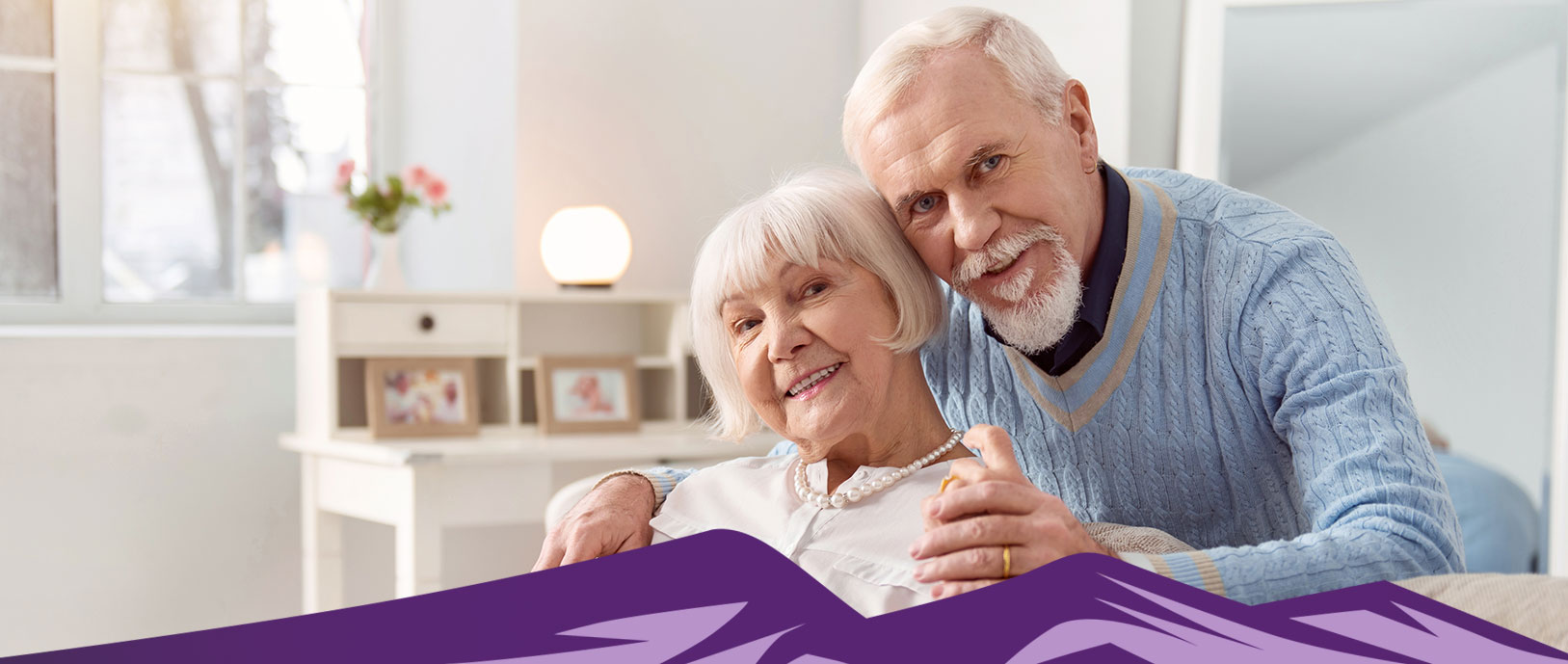 An older couple is showing affection for one another with hugs and hand holding