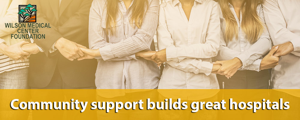 Banner picture of a a group of people (males and females) have their hands linked together. Banner says:

Community support builds great hospitals