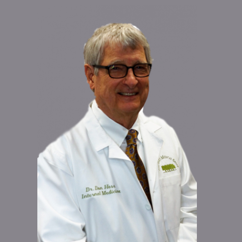 Banner picture of Dr In internal Medicine. He is smiling and wearing a medical coat and button down shirt with a tie and he is smiling.