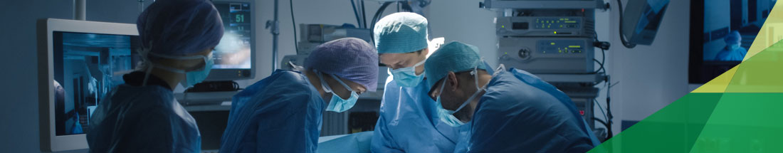 Medical Services: Picture of  five health professionals that are fully dressed in surgical attire in an operation room.