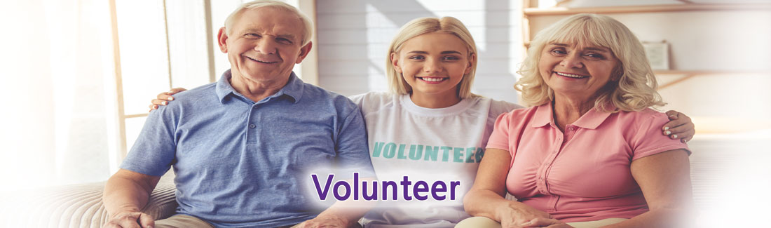 Banner picture of a young girl wearing a shirt that says VOLUNTEER. She is sitting on a couch in between an older couple. Banner says:
Volunteer