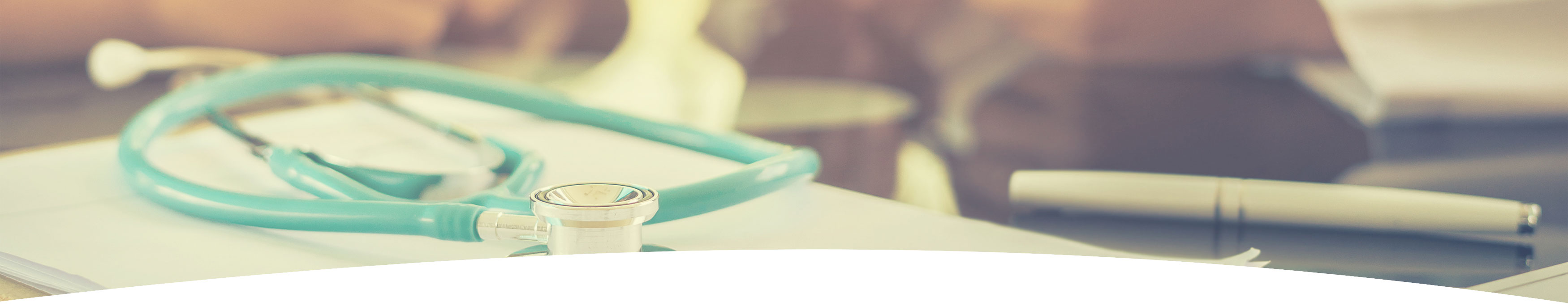 Banner picture of a stethoscope sitting on top of a Clipboard with a pen sitting next to it.
