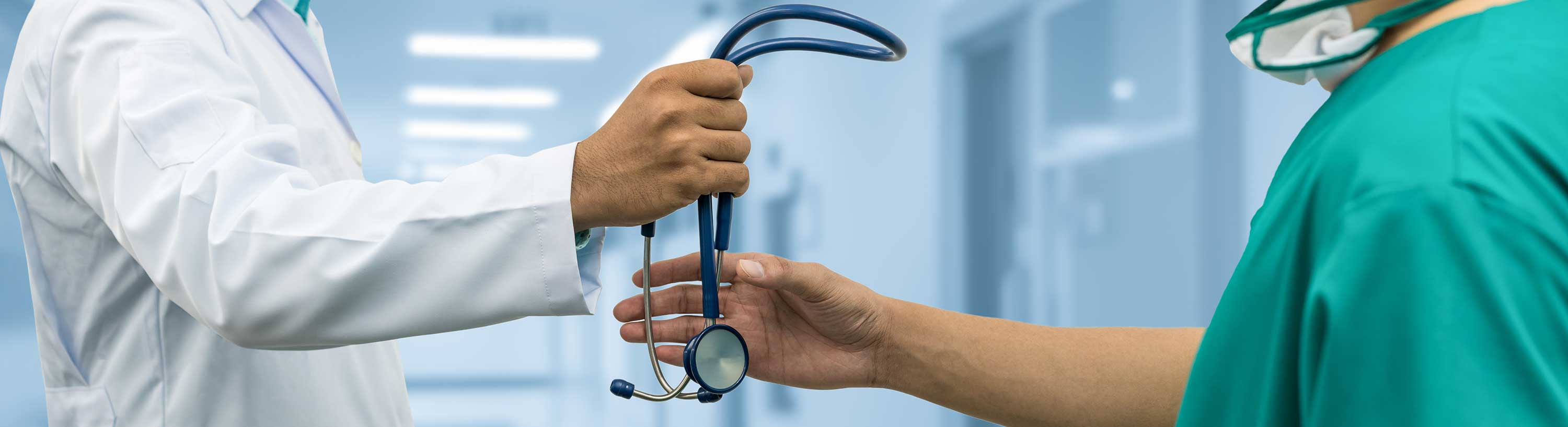 Banner picture of a male Physician handing a male Nurse a stethoscope.