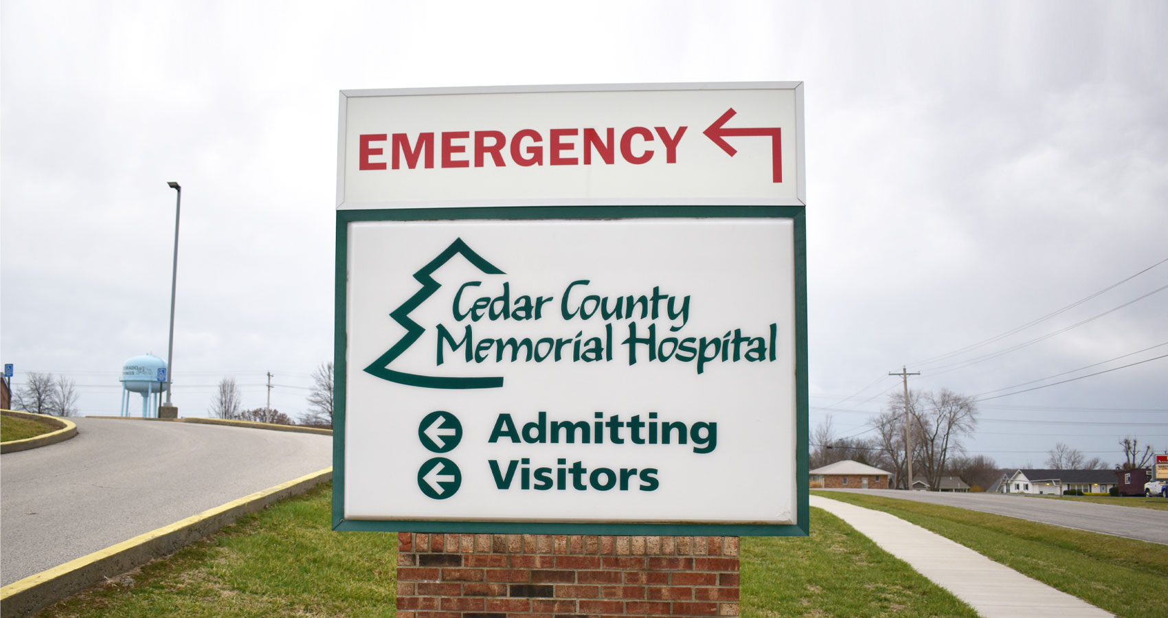 Banner picture of outdoor sign that says:

Cedar County Memorial Hospital
<- Admitting
<- Visitors