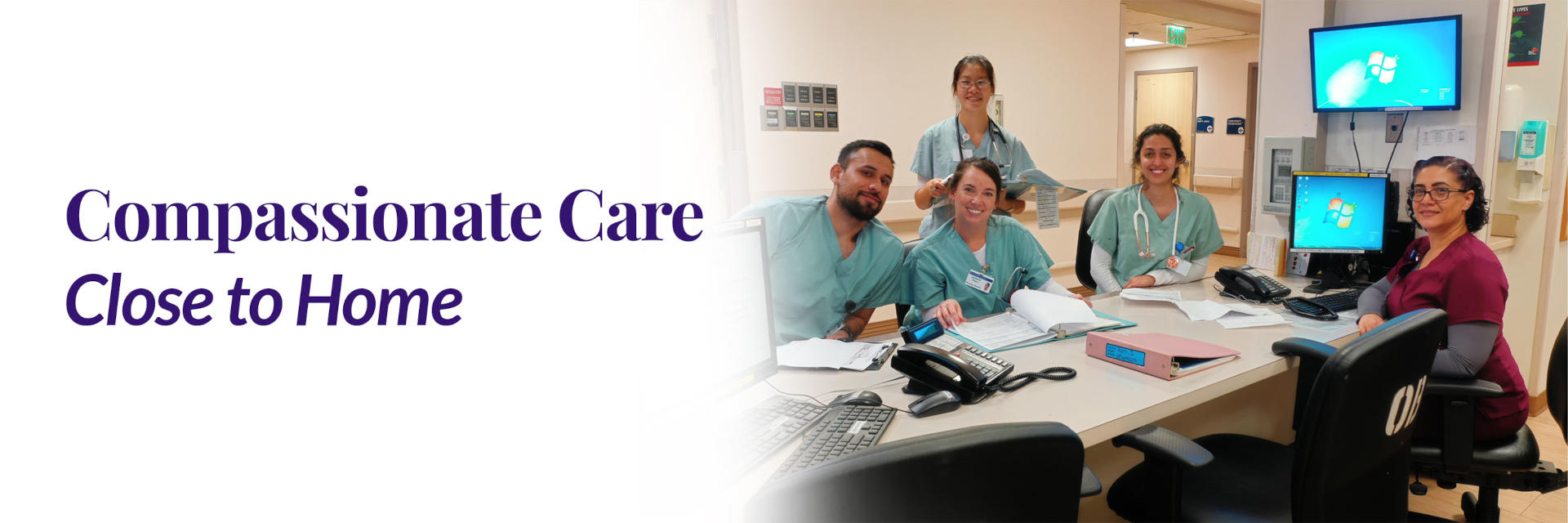 Banner picture of five smiling Nurses sitting at The Nurses Station. There are four females and one male.