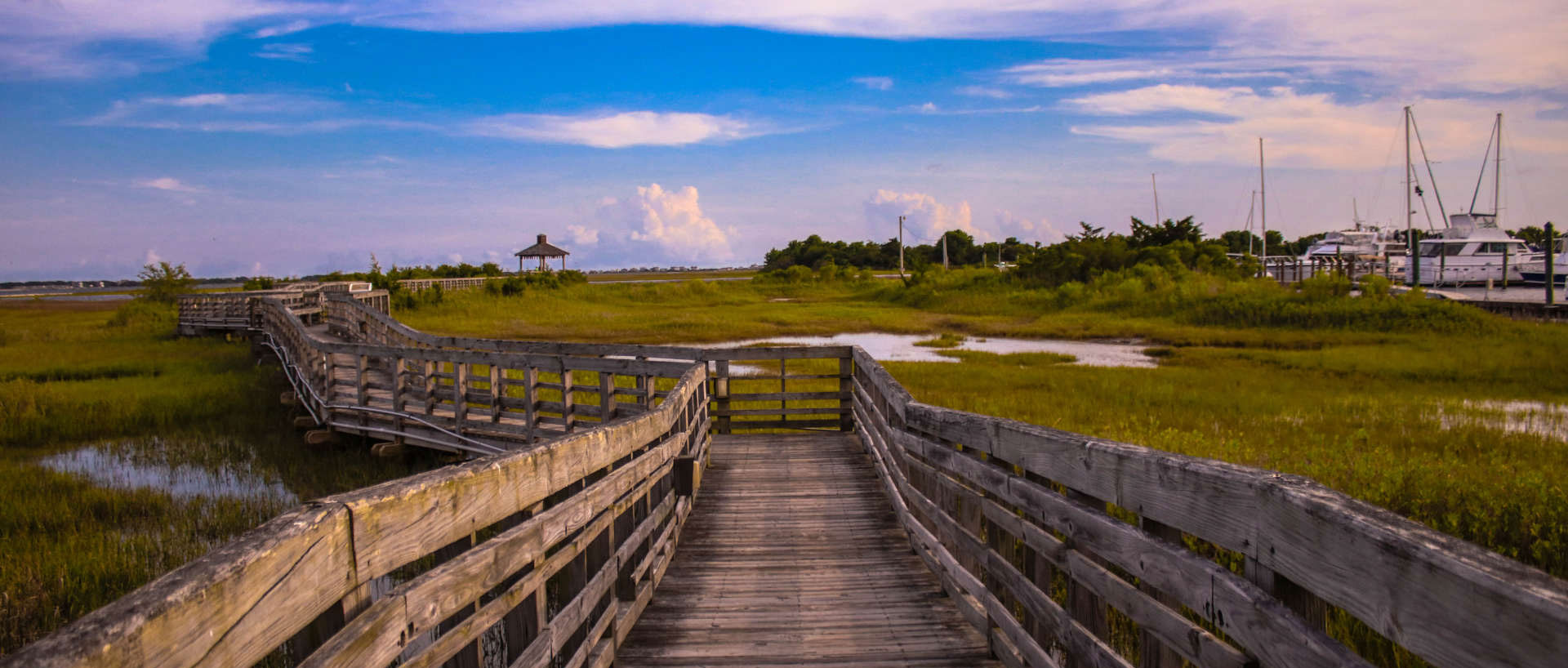 A beautiful, yet rustic wooden bridge leads the path to the skyline above.