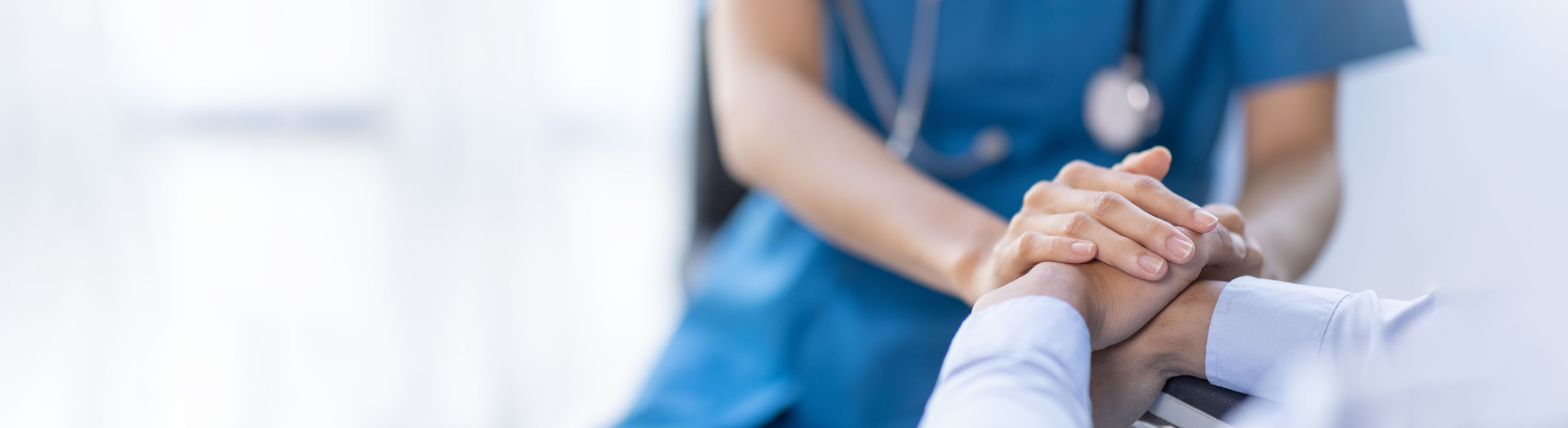 medical staff hold hand of patient