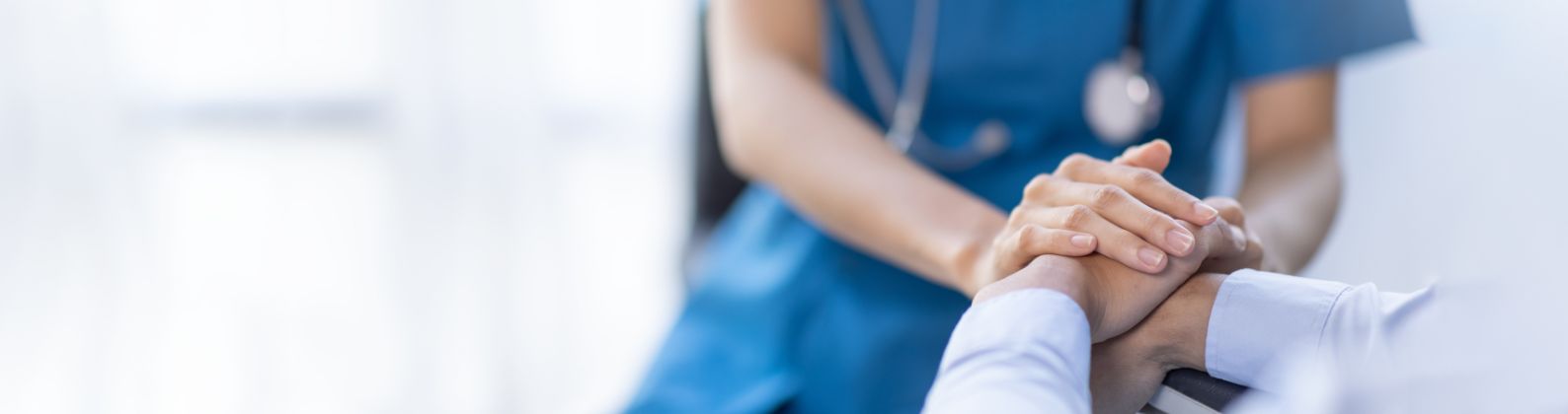 medical professional holding patient hand